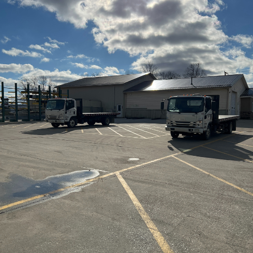 Box trucks with empty long beds.